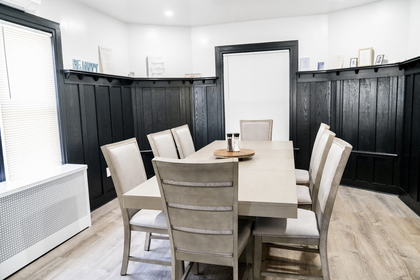 Shared dining room with a table and upholstered chairs